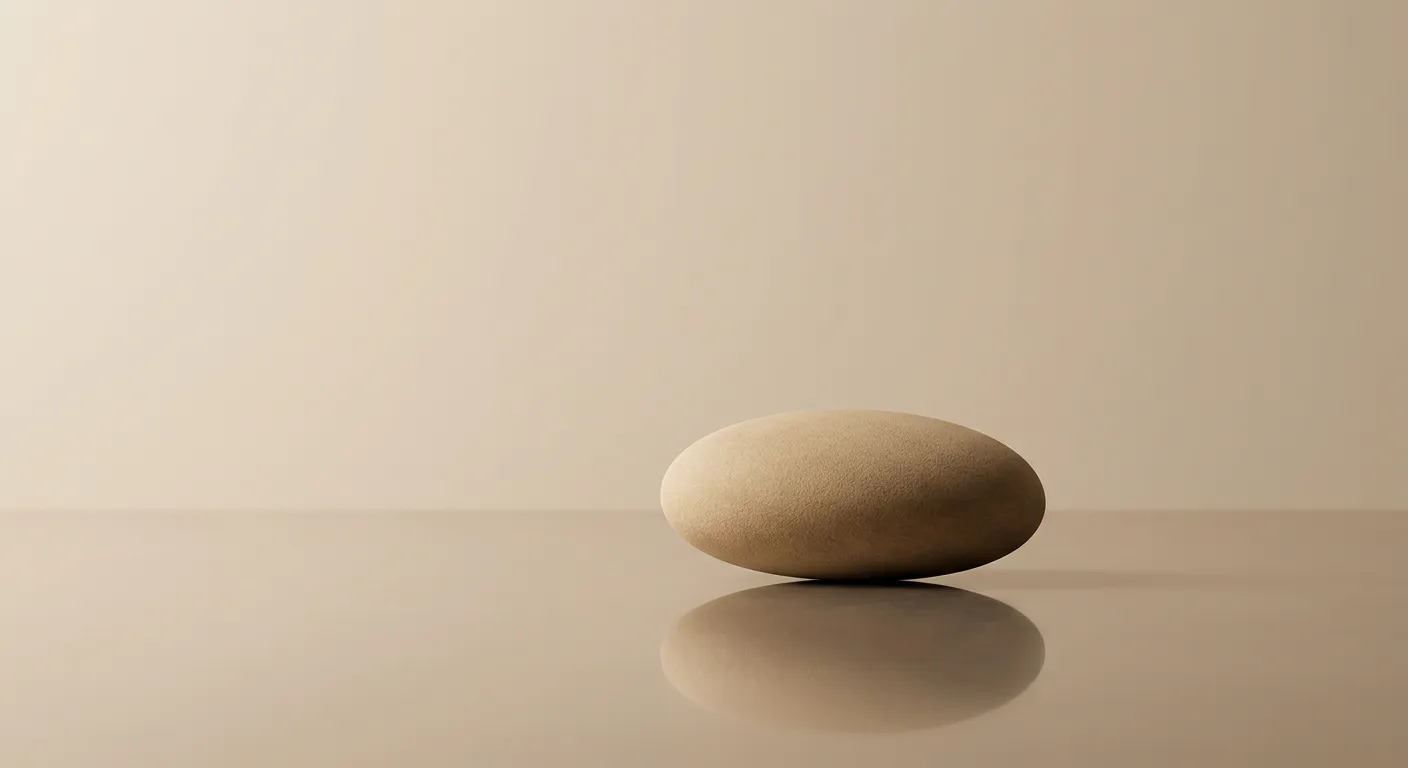 Minimalist abstract composition of a single smooth stone resting on a calm reflective surface, representing stable foundational settlement in a fluid environment